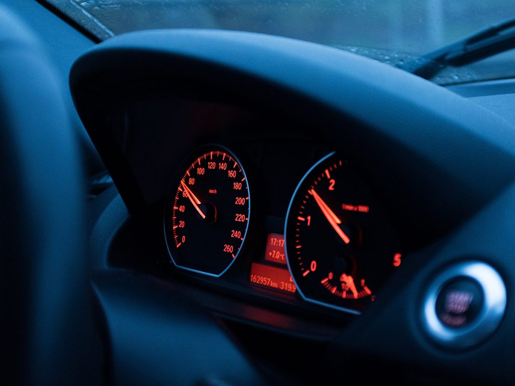 Ein Rot beleuchtetes, ansteigendes Auto-Tachometer